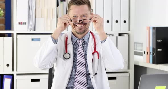 Man Doctor Taking Off Glasses for Vision and Crossing Arms in Office of Clinic  Movie Slow Motion