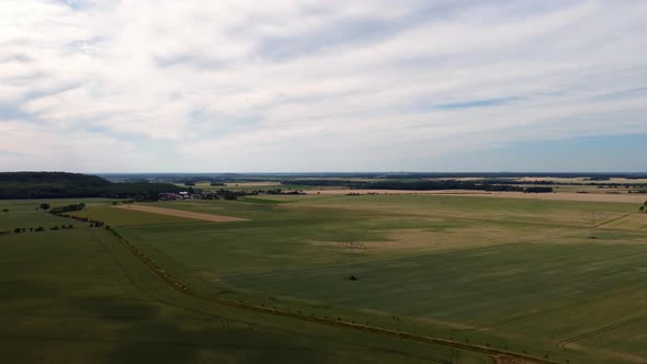 Fields in the distance large chimney that smokesMarvelous aerial view flight panorama curve flight