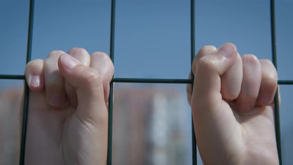 Childhood concept behind the fence. 