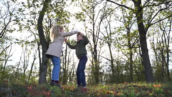 Happy Kids Playing in Forest Together Holding Hands and Spinning Around Then Hugging and Dancing