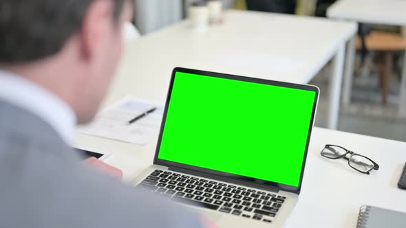 Businessman Using Laptop with Green Chroma Key Screen