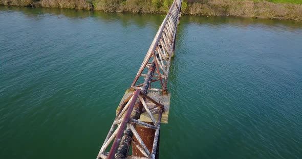 A Rusty Metal Pipe Across the River