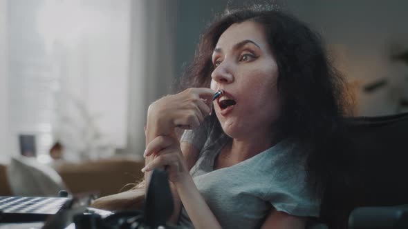 Woman with a Disability Applying Lipstick