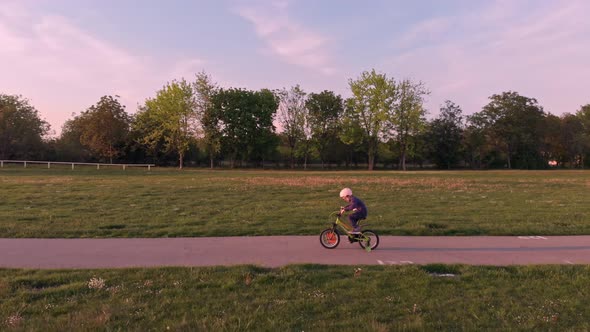 Boy On Bike with protective helmet Ride In Park