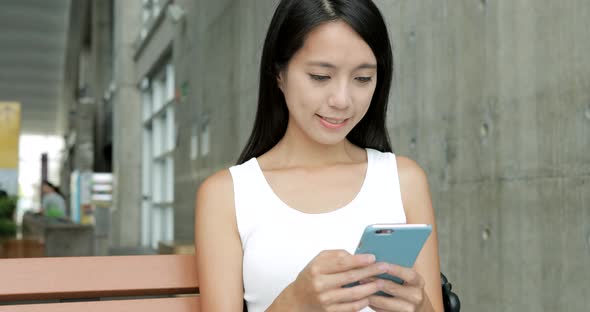 Woman using mobile phone in the university campus