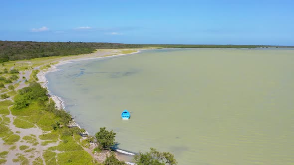 Blue fishing boat anchored at Oviedo Lagoon in Pedernales, Dominican Republic. Aerial