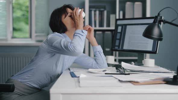 Sleepy Woman Working at Office