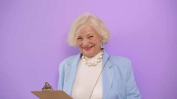 Attractive Business Woman of Mature Years Smiles at the Camera on an Isolated Background