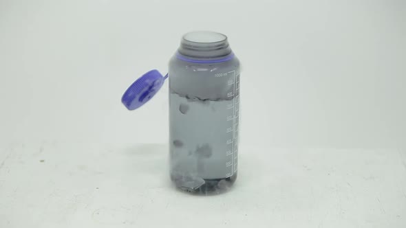 Dry ice cube bubbling in a bottle