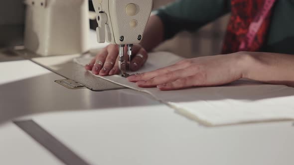 Hands Of Girl Sewing On Sewing Machine