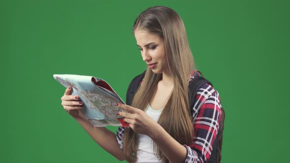Happy Young Beautiful Woman Tourist Backpacker Smiling Looking at the Map