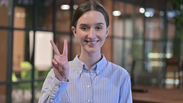 Victory Sign By Successful Young Woman