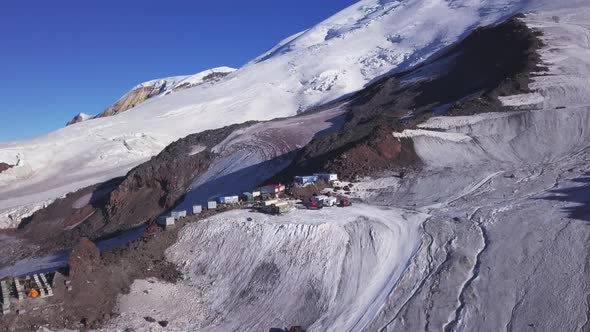 A row of houses built on a snowy mountain slope