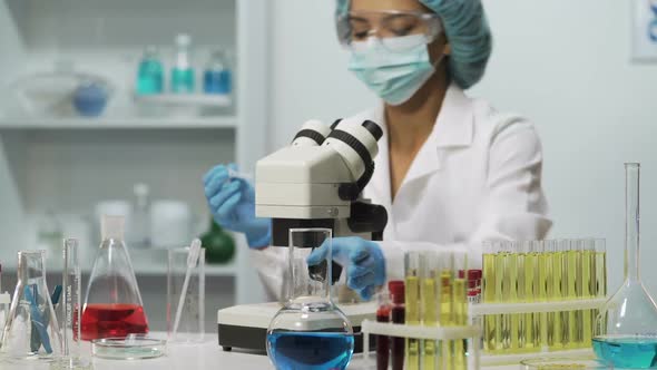Biracial Lab Assistant Working in Laboratory, Doing Medical Test, Research