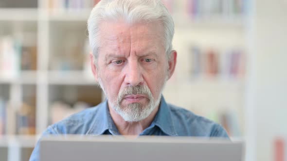 Close Up of Old Businessman Working on Laptop 