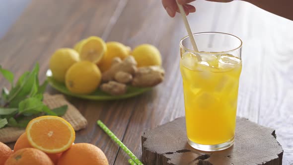 A Summer Drink With Lemon And Orange, Served Chilled, Ice Cubes. Sweet And Refreshing Orange Color