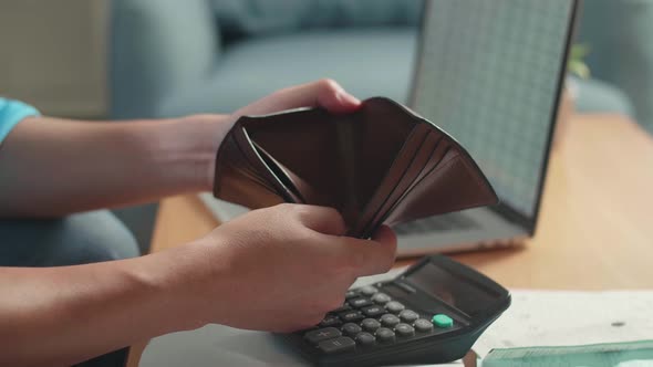 Close Up Of Man's Hand Holding And Opening The Wallet To Check Money