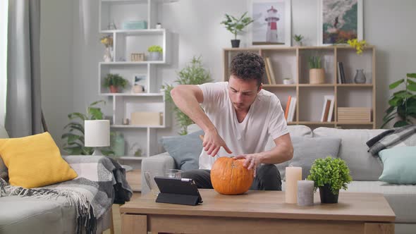 Young Man Carves Jack the Lantern