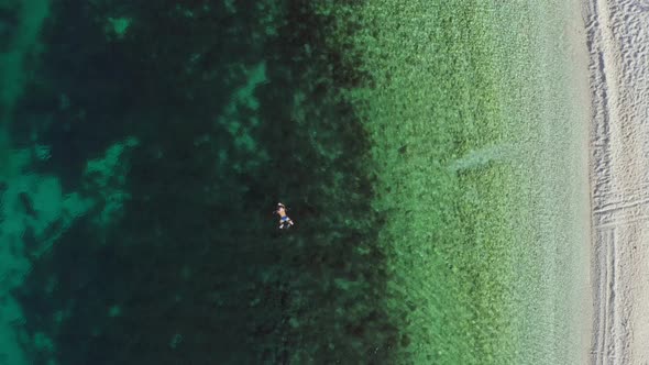 Aerial View of a Girl Swimming in the Ocean