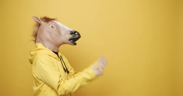 Man with Horse Mask is Praying Tired Confused on Yellow Background