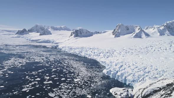 Aerial Flight Over Snow, Ice Antarctica Shoreline