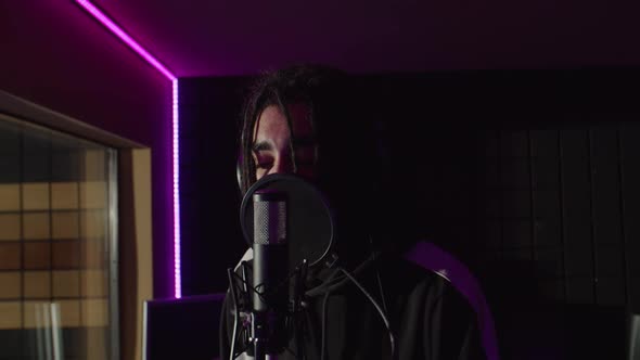 Portrait of Charismatic Male Hip Hop Artist Showing Thumbs Up in Sound Recording Studio