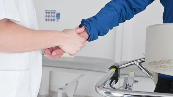 Close Up of Physiotherapist Assisting a Patient with Amyotrophic Lateral Sclerosis