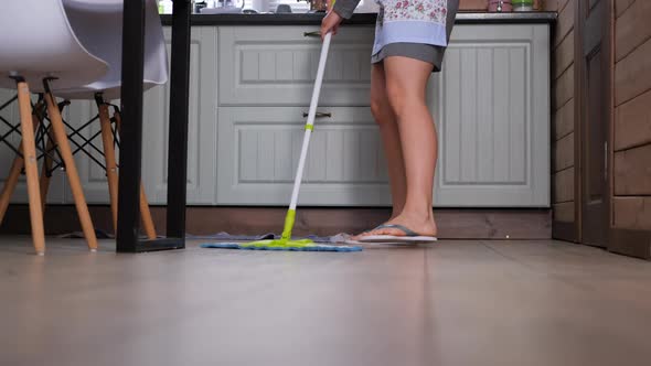 Woman Washing Floor with Mop in the Kitchen