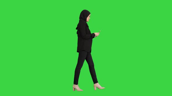 Pretty Woman in Hijab Walking and Counting Money on a Green Screen, Chroma Key