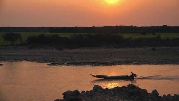 Medium Exterior Slow Motion Shot of Fishing Boat at Sunset