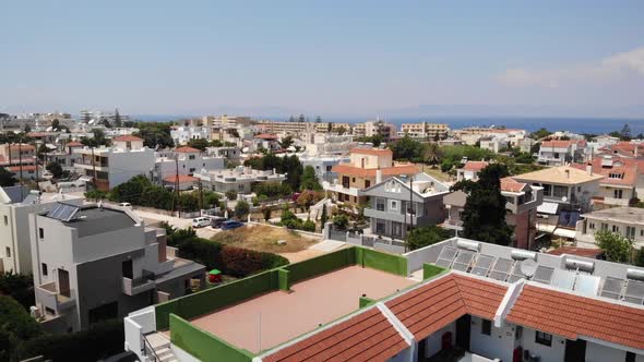 Beach Hotels And Apartments In Ialysos Town On Rhodes, Greece. - aerial pullback