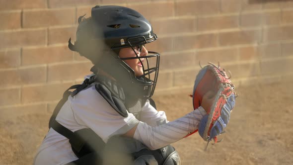 Boy plays catcher in a little league baseball game.