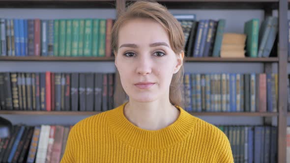 Young Woman Pointing toward Camera, Portrait