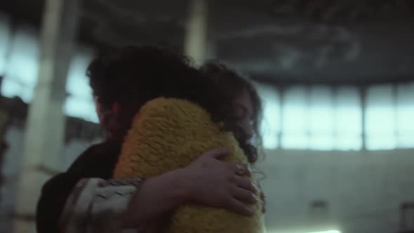 Girls Embracing and Dancing in Abandoned Building