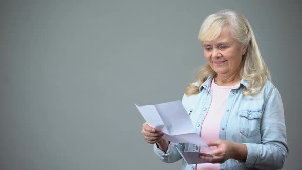 Aged Retiree Lady Reading Letter From Children Receiving Good News Loan Approval
