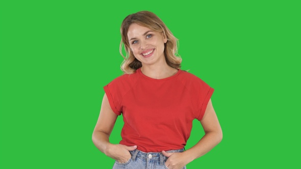 Walking woman in jeans and t-shirt on a Green Screen, Chroma Key.
