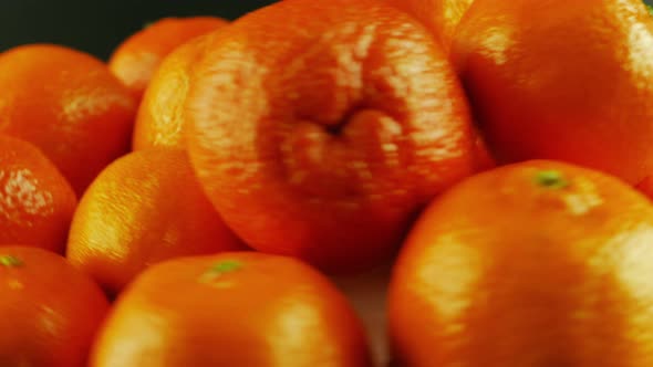 Macro Shot of Rotating Tangerines - Black Background