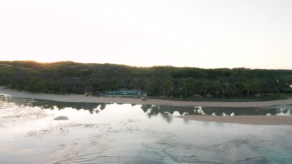 Perfect serene morning on tropic coast of Fiji with low seawater in bay, aerial