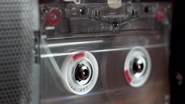 vintage audio cassette begins to play in the tape deck