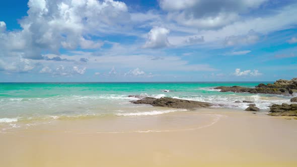 Seascape in sunny day white clouds beautiful blue sky rock and sand beach Phuket Thailand