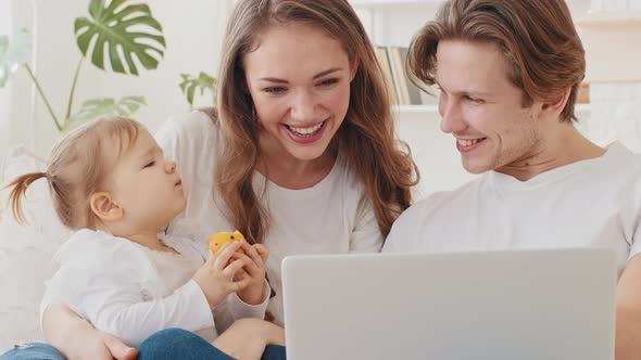 Family Uses Laptop Internet Shopping Online Sitting on Home Couch