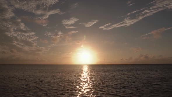 Coastal beach sunrise in South Florida with clouds and ocean.