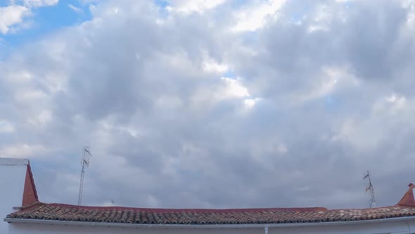 Time lapse of a cloudy sky from a city window alt