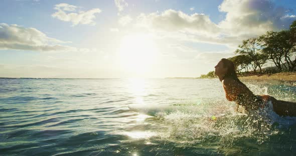 Young Woman Surfing at Susnet