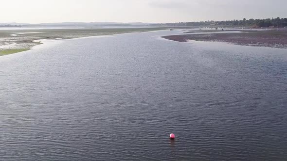 Day time flying over the coastal town of Lympstone in East Devon in South West England. The beach is