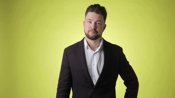 Young Man in Office Suit Showing Thumb Down Gesture Saying No Dislike Sign