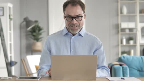 Businessman Celebrating Success on Laptop