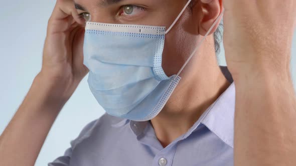 Extreme Closeup of Man Putting on Disposable Face Mask
