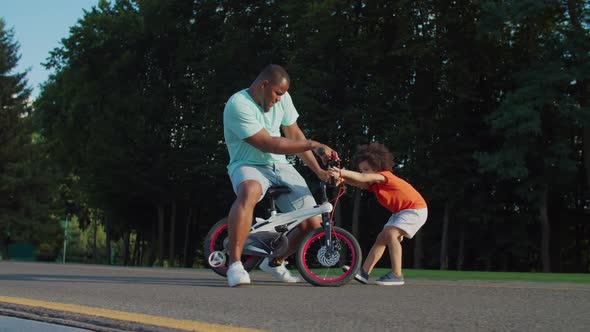 African Family with Kid Having Fun Riding Bicycle