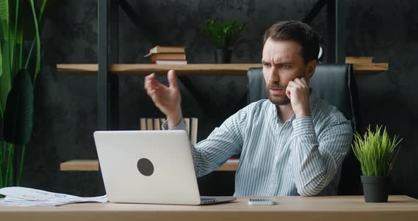 Shocked Male Entrepreneur Upset with a Bad Deal Looking at Laptop Screen Reaction on Crisis